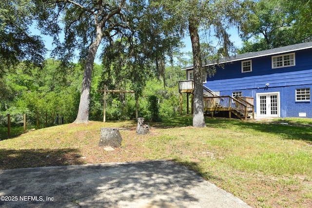 2873 Creek St, Middleburg, FL 32068 - view of green lawn with french doors, stairs, and a wooden deck