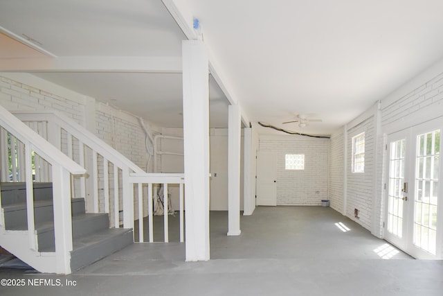 2873 Creek St, Middleburg, FL 32068 - entrance foyer with brick wall, concrete flooring, a ceiling fan, and stairs