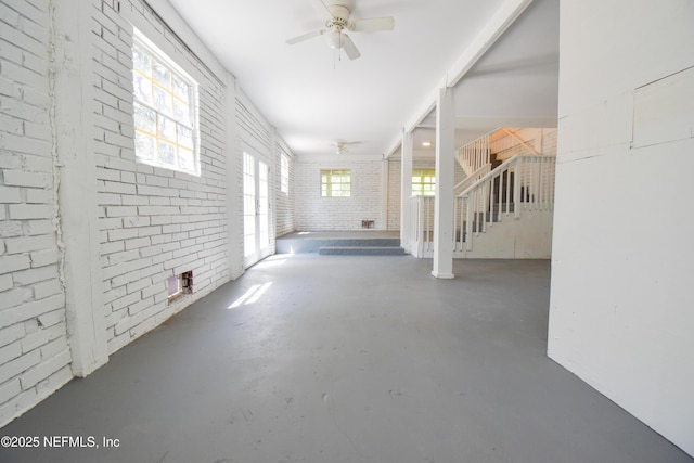 2873 Creek St, Middleburg, FL 32068 - hall featuring concrete flooring, stairs, and brick wall
