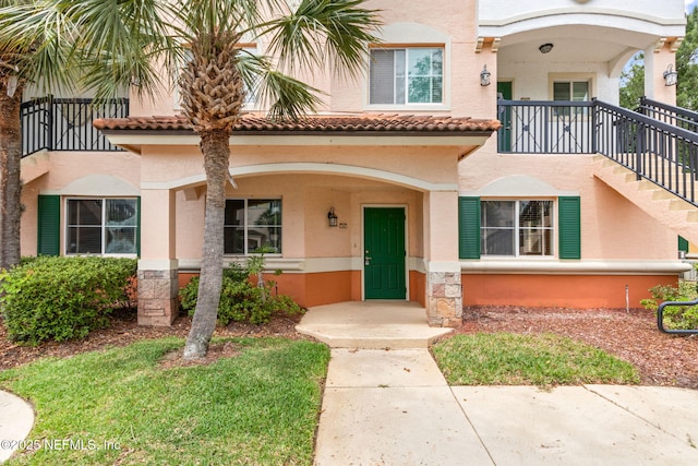 view of front of home with stucco siding and a tile roof