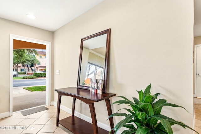 entrance foyer with light tile patterned flooring and baseboards
