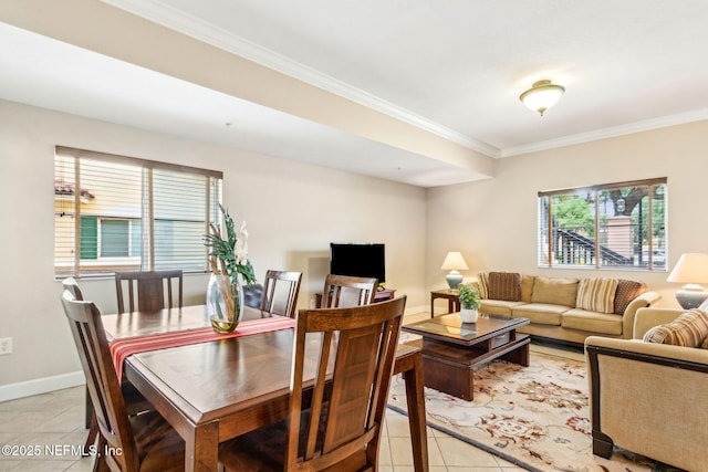 living area with light tile patterned floors, crown molding, plenty of natural light, and baseboards