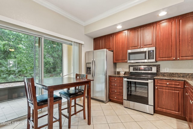 kitchen with appliances with stainless steel finishes, ornamental molding, light tile patterned floors, recessed lighting, and brown cabinetry