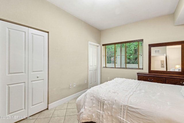 bedroom with light tile patterned floors and baseboards