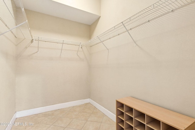 walk in closet featuring light tile patterned flooring