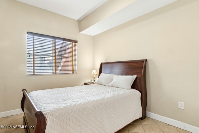 bedroom featuring baseboards and tile patterned floors