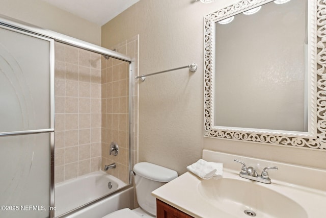full bathroom with toilet, vanity, and bath / shower combo with glass door
