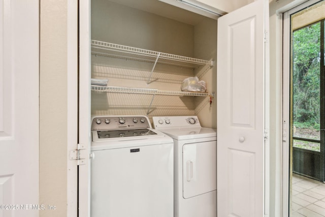 laundry area featuring independent washer and dryer and light tile patterned floors