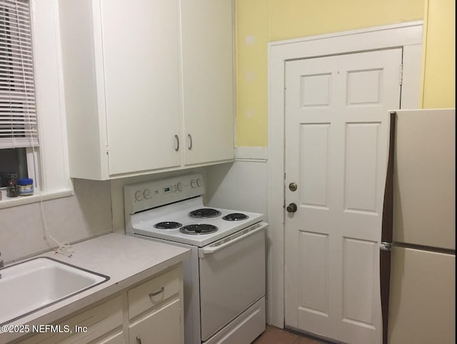2523 Forbes St, Jacksonville, FL 32204 - kitchen with white appliances, a sink, light countertops, and white cabinets