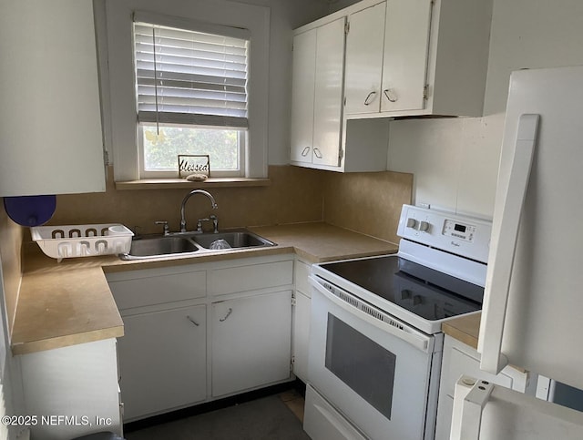 2523 Forbes St, Jacksonville, FL 32204 - kitchen with white electric range, a sink, refrigerator, light countertops, and white cabinets