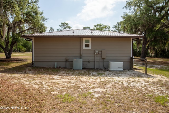 7013 Elfo Rd, Keystone Heights, FL 32656 - back of house featuring central air condition unit and metal roof