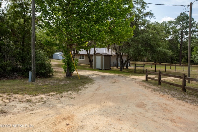 7013 Elfo Rd, Keystone Heights, FL 32656 - view of front of home with a shed, fence, an outbuilding, and driveway