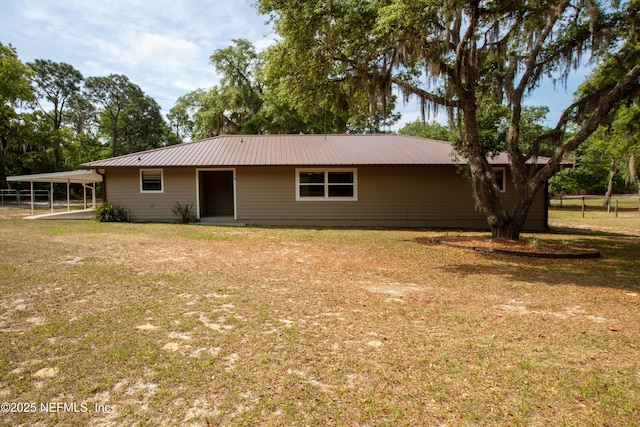 7013 Elfo Rd, Keystone Heights, FL 32656 - view of front of house with metal roof, a front lawn, and an attached carport