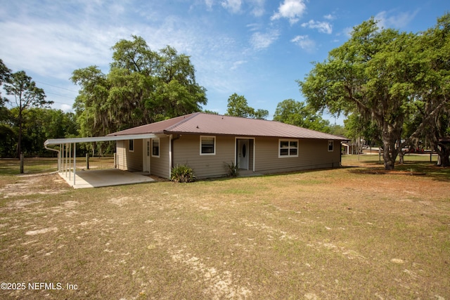 7013 Elfo Rd, Keystone Heights, FL 32656 - back of property featuring an attached carport, a yard, and metal roof