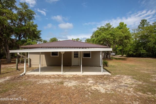 7013 Elfo Rd, Keystone Heights, FL 32656 - rear view of house with metal roof and a lawn
