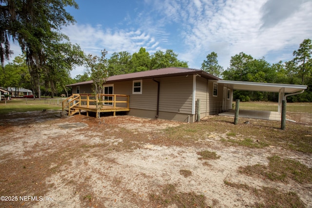 7013 Elfo Rd, Keystone Heights, FL 32656 - view of side of home featuring a wooden deck, a carport, and metal roof