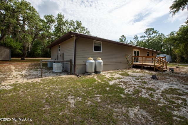 7013 Elfo Rd, Keystone Heights, FL 32656 - rear view of property with a shed, a deck, an outbuilding, and cooling unit