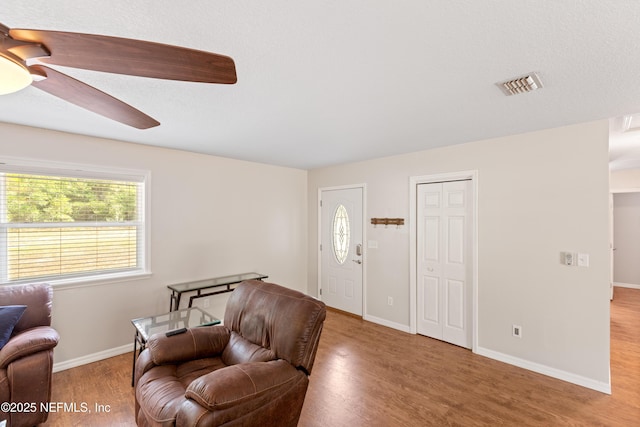 7013 Elfo Rd, Keystone Heights, FL 32656 - living area with wood finished floors, ceiling fan, and baseboards
