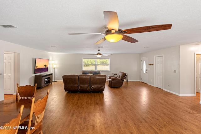 7013 Elfo Rd, Keystone Heights, FL 32656 - living room featuring wood finished floors, a ceiling fan, and baseboards