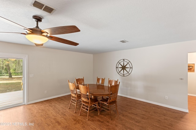 7013 Elfo Rd, Keystone Heights, FL 32656 - dining space with wood finished floors, baseboards, ceiling fan, and a textured ceiling