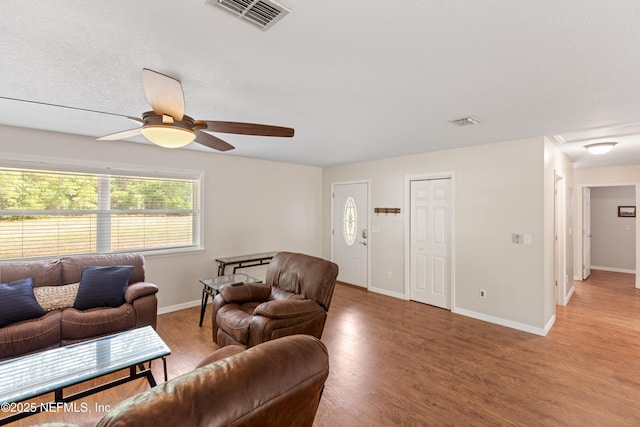 7013 Elfo Rd, Keystone Heights, FL 32656 - living area featuring a ceiling fan, light wood-style floors, and baseboards