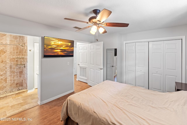 7013 Elfo Rd, Keystone Heights, FL 32656 - bedroom featuring a ceiling fan, a closet, wood finished floors, and baseboards