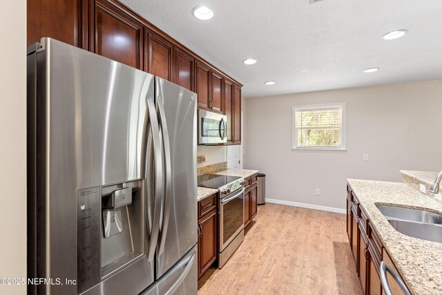 7013 Elfo Rd, Keystone Heights, FL 32656 - kitchen with stainless steel appliances, a sink, light wood-type flooring, recessed lighting, and baseboards