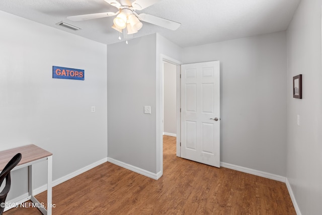 7013 Elfo Rd, Keystone Heights, FL 32656 - unfurnished office featuring baseboards, ceiling fan, and wood finished floors