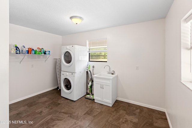 7013 Elfo Rd, Keystone Heights, FL 32656 - washroom with stacked washing machine and dryer, baseboards, and cabinet space