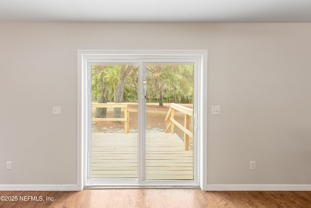 7013 Elfo Rd, Keystone Heights, FL 32656 - doorway with baseboards and wood finished floors