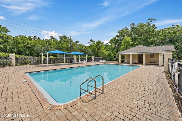 6700 Bowden Rd Unit 1201, Jacksonville, FL 32216 - community pool with a patio, an outbuilding, and view of scattered trees
