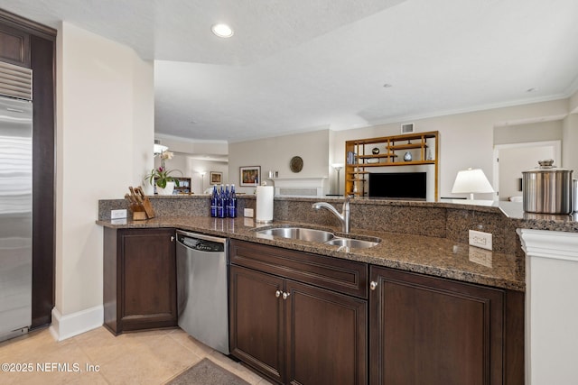 2358 Riverside Ave Unit 304, Jacksonville, FL 32204 - kitchen featuring appliances with stainless steel finishes, a sink, open floor plan, dark stone counters, and crown molding