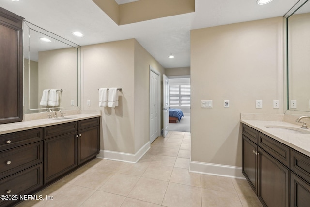 2358 Riverside Ave Unit 304, Jacksonville, FL 32204 - ensuite bathroom with baseboards, two vanities, tile patterned floors, and recessed lighting