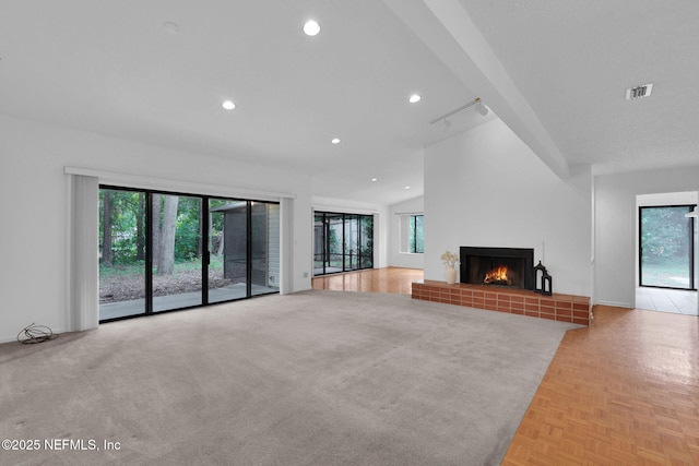 11711 Sparkleberry Ln, Jacksonville, FL 32223 - unfurnished living room with a tiled fireplace, recessed lighting, and vaulted ceiling