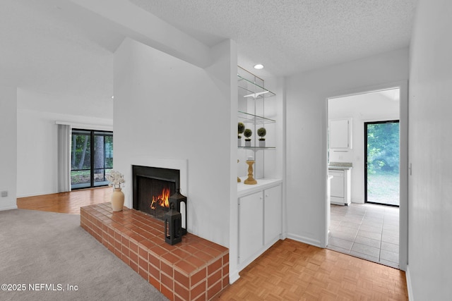 11711 Sparkleberry Ln, Jacksonville, FL 32223 - unfurnished living room featuring a warm lit fireplace, plenty of natural light, a textured ceiling, and baseboards