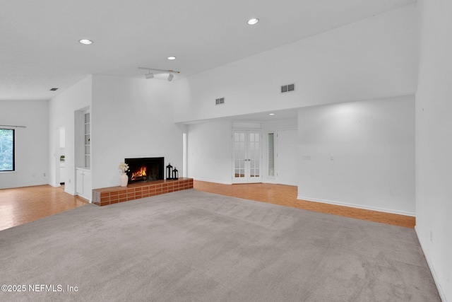 11711 Sparkleberry Ln, Jacksonville, FL 32223 - unfurnished living room with carpet flooring, recessed lighting, a fireplace, baseboards, and french doors