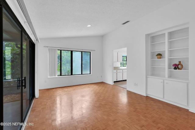 11711 Sparkleberry Ln, Jacksonville, FL 32223 - unfurnished room with a textured ceiling, vaulted ceiling, and baseboards