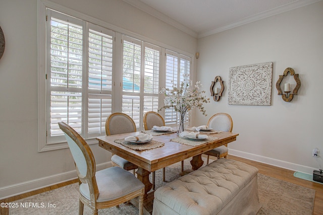 9155 June Ln, Saint Augustine Beach, FL 32080 - dining room featuring healthy amount of natural light, wood finished floors, baseboards, and ornamental molding