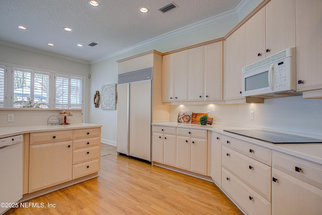 9155 June Ln, Saint Augustine Beach, FL 32080 - kitchen featuring white appliances, ornamental molding, a textured ceiling, light countertops, and light wood finished floors