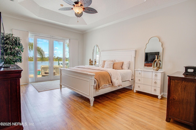 9155 June Ln, Saint Augustine Beach, FL 32080 - bedroom with access to outside, light wood-style flooring, crown molding, a raised ceiling, and a ceiling fan