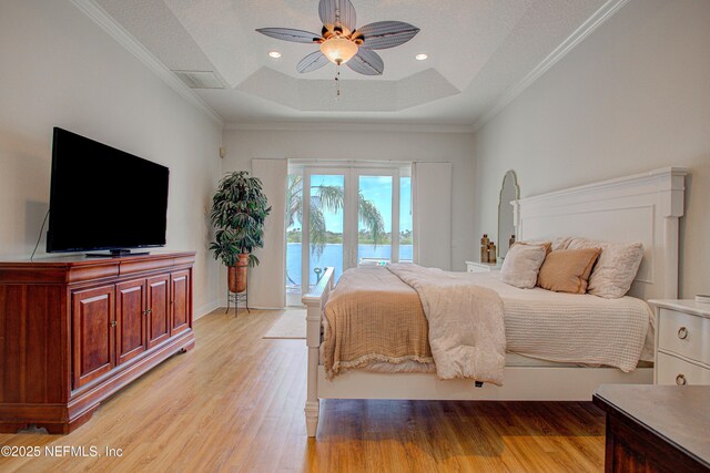 9155 June Ln, Saint Augustine Beach, FL 32080 - bedroom featuring a raised ceiling, access to exterior, light wood-style floors, ceiling fan, and ornamental molding