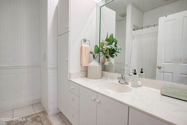 9155 June Ln, Saint Augustine Beach, FL 32080 - bathroom featuring vanity, tile patterned floors, and a wainscoted wall