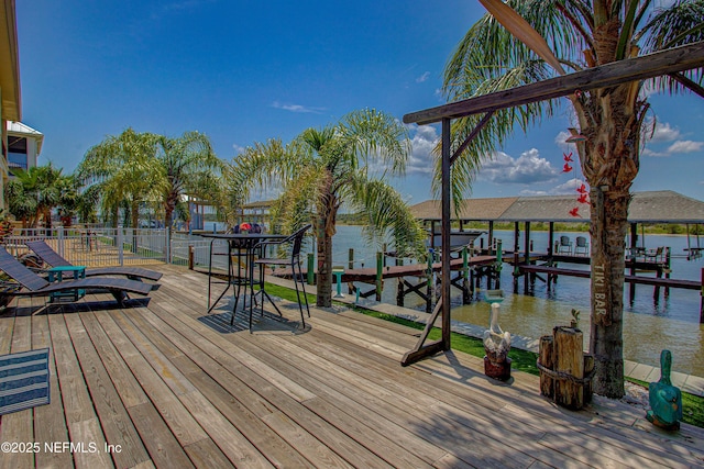 9155 June Ln, Saint Augustine Beach, FL 32080 - wooden deck featuring boat lift, a dock, and a water view