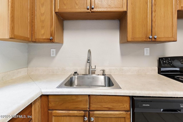 kitchen with dishwasher, a sink, light countertops, and range