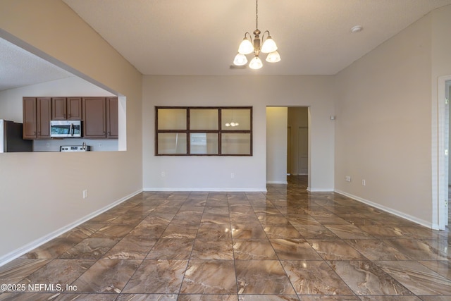 1413 Heather Ct, Saint Augustine, FL 32092 - unfurnished dining area featuring a chandelier, dark marble finish floors, vaulted ceiling, and baseboards