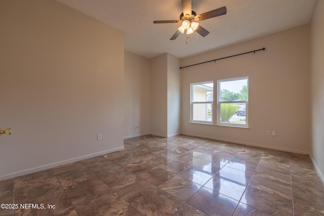 1413 Heather Ct, Saint Augustine, FL 32092 - spare room featuring marble look tiles, a textured ceiling, a ceiling fan, and baseboards