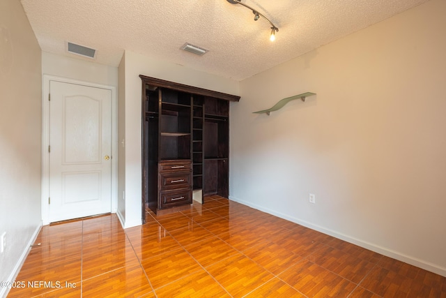 1413 Heather Ct, Saint Augustine, FL 32092 - unfurnished bedroom featuring light wood-style flooring, baseboards, a closet, and a textured ceiling