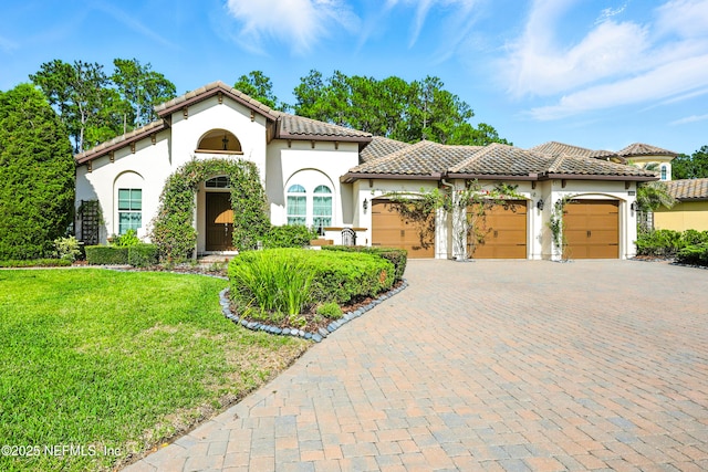 2919 Brettungar Dr, Jacksonville, FL 32224 - mediterranean / spanish-style house with a garage, a tile roof, stucco siding, a front lawn, and decorative driveway