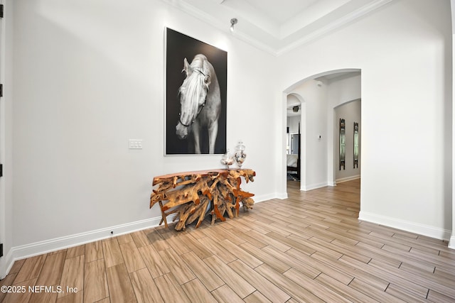 2919 Brettungar Dr, Jacksonville, FL 32224 - entrance foyer with light wood-style flooring, arched walkways, and crown molding