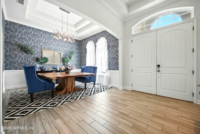 2919 Brettungar Dr, Jacksonville, FL 32224 - entryway with wallpapered walls, a chandelier, a tray ceiling, plenty of natural light, and wood finished floors